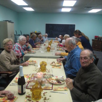 Group of seniors sitting at teh table during Thanksgiving diiner