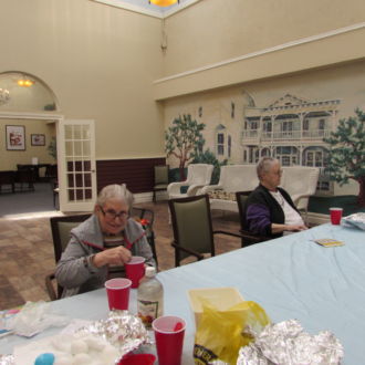 Senior ladies drinking seltzer at teh table