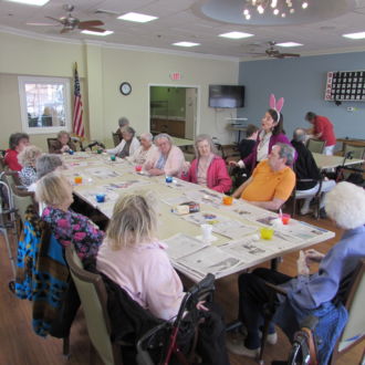 Group of seniors at teh arts and crafts table